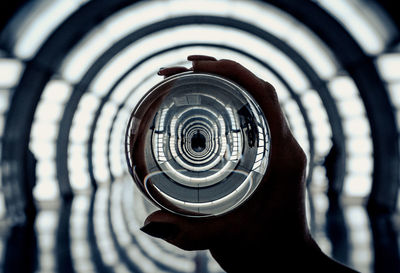 Close-up of human hand holding crystal ball