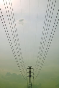 Low angle view of electricity pylon against sky