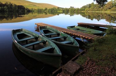Boats moored in lake