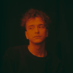 Portrait of young man against black background
