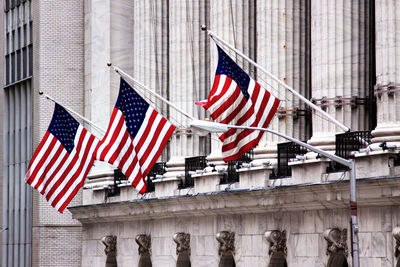 Low angle view of flag against building in city