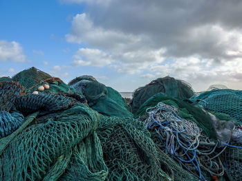 Close-up of fishing net against blue sky