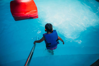 High angle view of girl swimming in pool