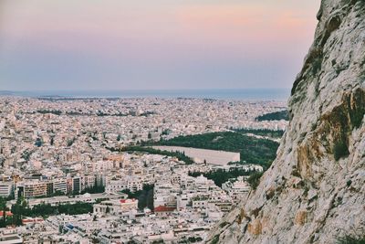 Aerial view of townscape by sea against sky
