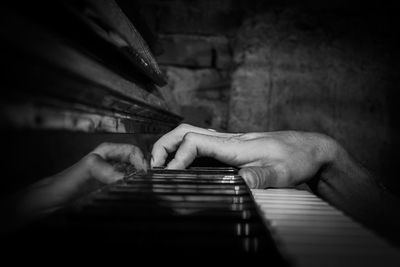 Midsection of man playing piano