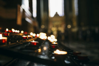 Candles igniting in dark church