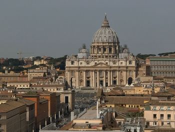 Cathedral amidst buildings in city against clear sky