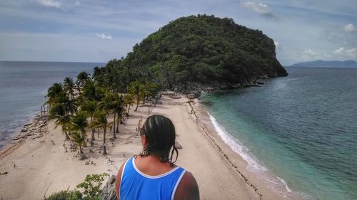 Rear view of woman standing on beach