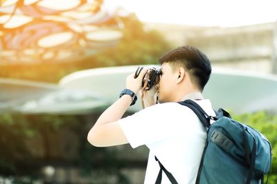 Rear view of man photographing