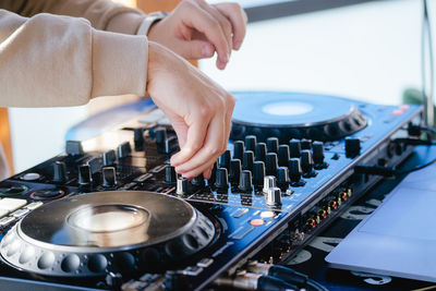 Cropped hand of man using sound mixer