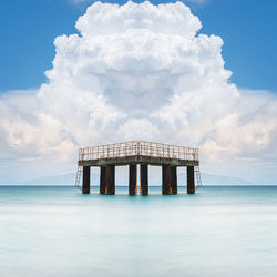 Lifeguard hut on sea against sky