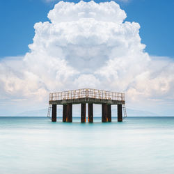 Lifeguard hut on sea against sky