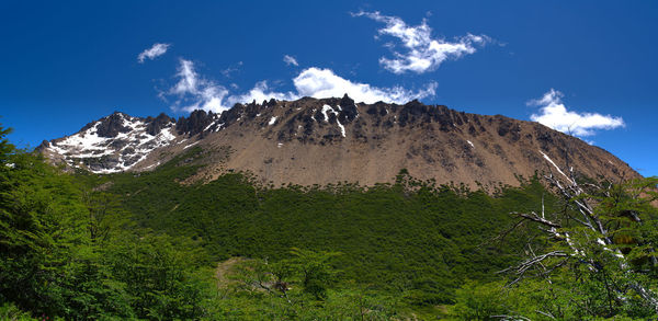 Low angle view of mountain against blue sky