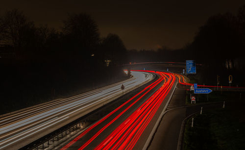 Long exposure, white front and red rear lights as car light strips at night