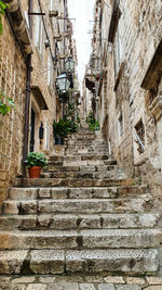 Low angle view of staircase amidst buildings in city