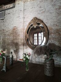 Flower vase on table against wall