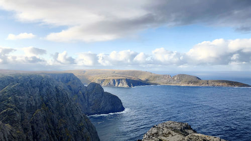 Panoramic view of sea and mountains against sky