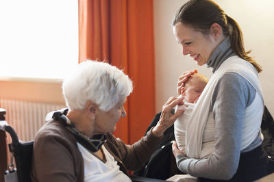 Old woman meeting her great granddaughter