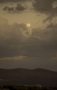 Low angle view of moon at sunset