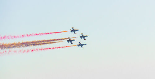 Low angle view of airplane flying against sky