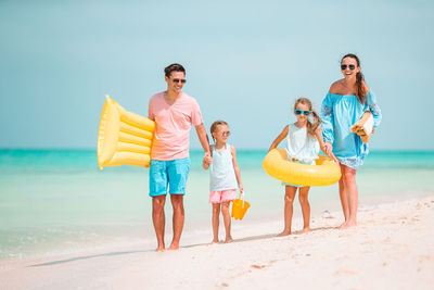 Family standing on beach
