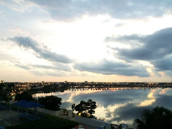 Scenic view of sea against cloudy sky at sunset