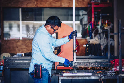 Side view of man working in factory