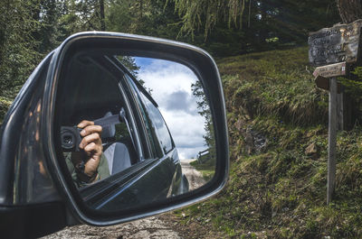 Side-view mirror of car with reflection