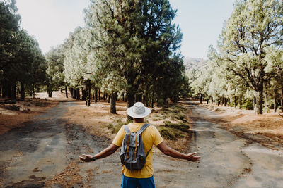 Rear view of woman walking on field