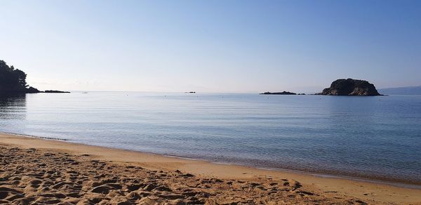 Scenic view of sea against clear sky during sunset