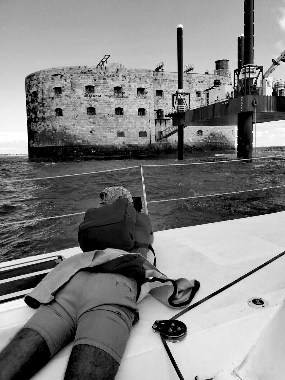 MAN WITH UMBRELLA ON BOAT