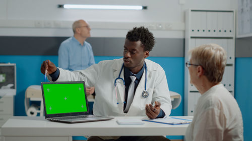 Doctor showing digital tablet in clinic