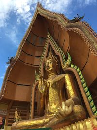 Low angle view of statue against building