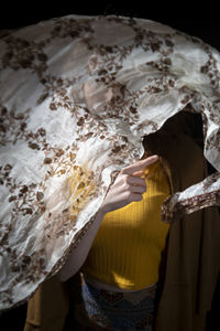 Midsection of woman wearing wedding dress