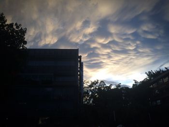 Low angle view of built structure against clouds