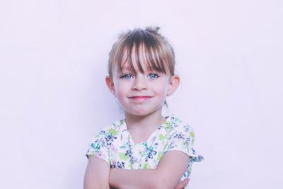 Portrait of cute girl against pink background