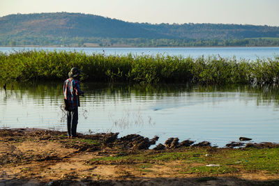Man standing at lakeshore