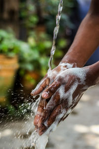 Close-up of hand splashing water