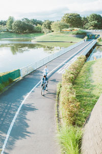 Man with bicycle on road against sky