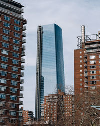 Low angle view of modern buildings against sky in city