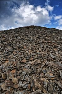 Low angle view of rocks on rock against sky