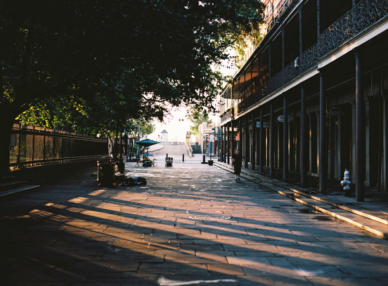 the way forward, architecture, built structure, building exterior, diminishing perspective, street, city, vanishing point, tree, transportation, railing, sunlight, incidental people, shadow, road, building, sidewalk, street light, walkway, sky