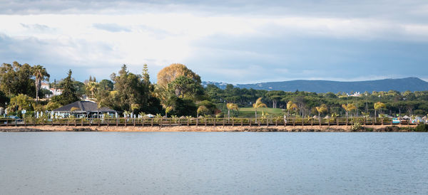 Scenic view of trees and buildings against sky