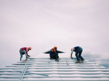 Low angle view of woman standing against sky