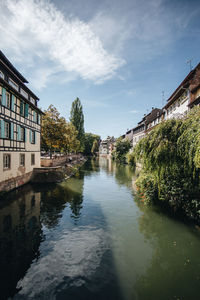 Canal amidst buildings against sky