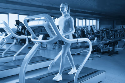 Rear view of woman exercising in gym