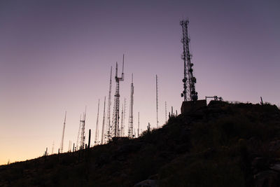 Low angle view of buildings against clear sky during sunset