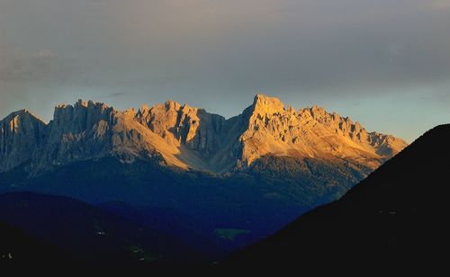 Scenic view of mountains against cloudy sky