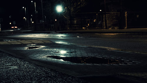 Surface level of wet street at night