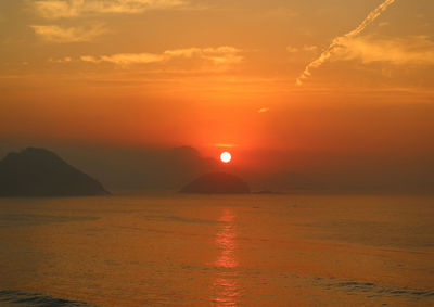 Scenic view of sea against romantic sky at sunset